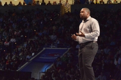 Jon Gosier addressing a large arena audience