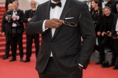 Jon Gosier holding sunglasses on the Cannes red carpet in 2026