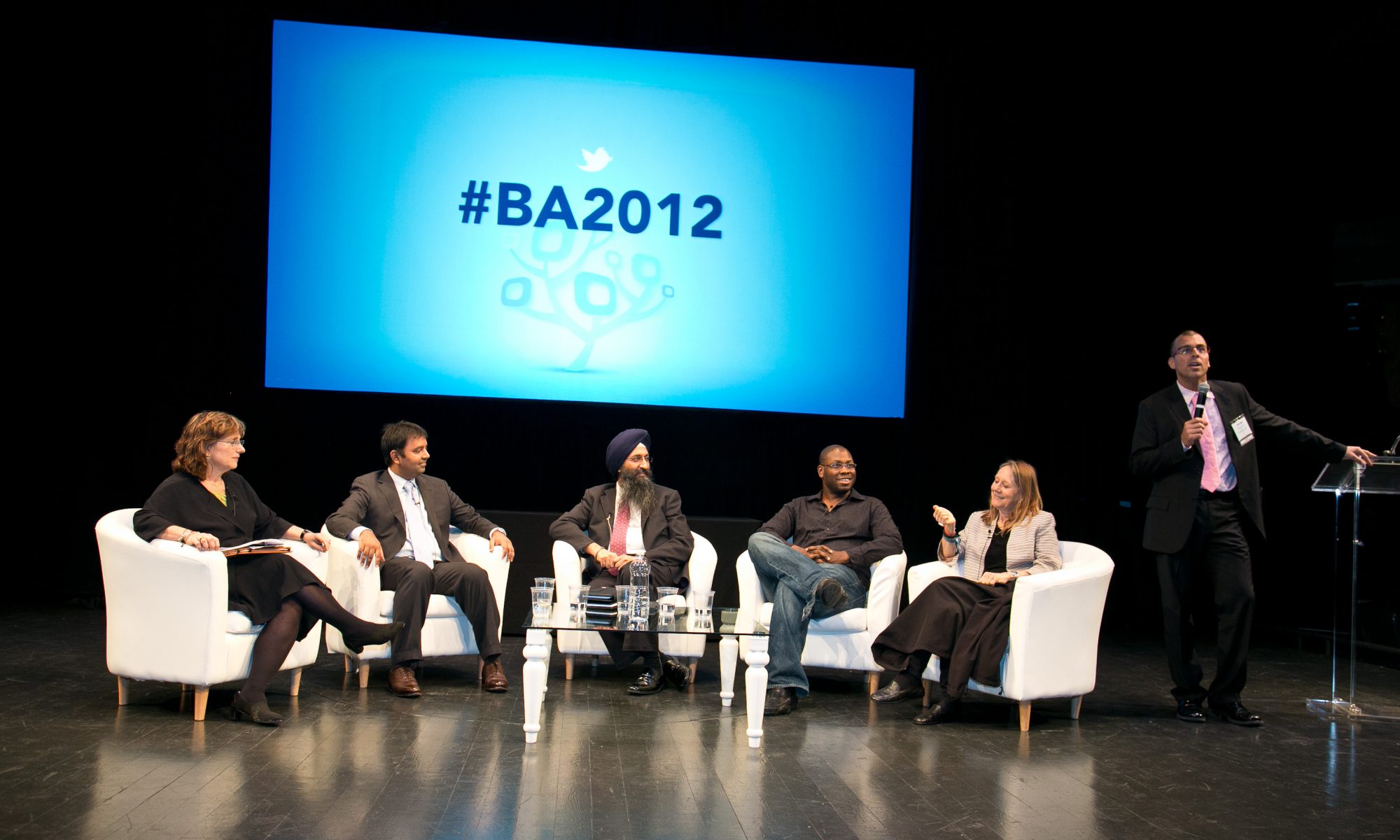 Jon Gosier speaks on a panel with investors, billionaires, and philanthropists.